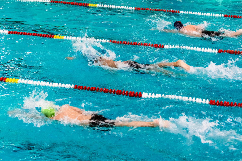 Swimmers in lanes racing to the left